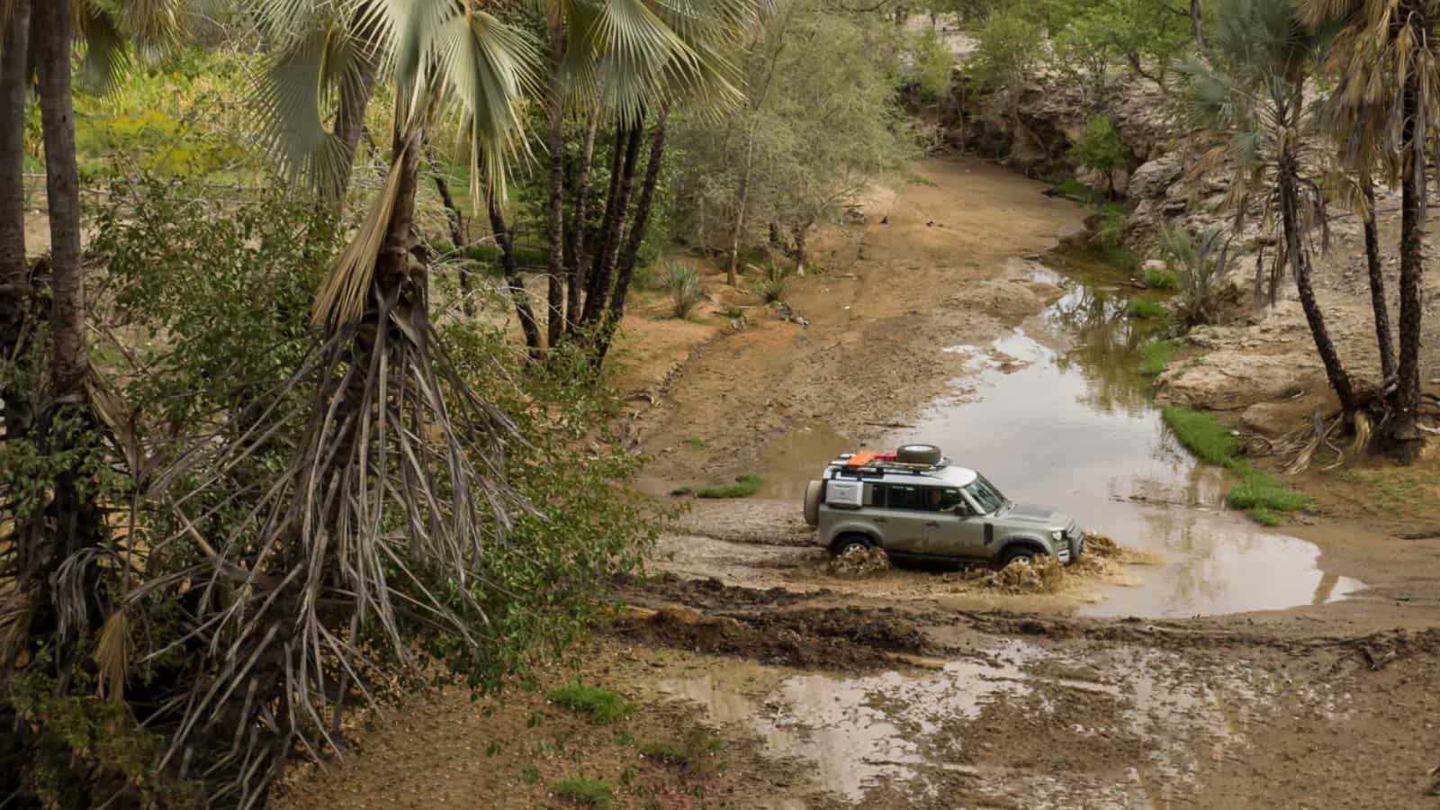 Range Rover Defender driving in mud