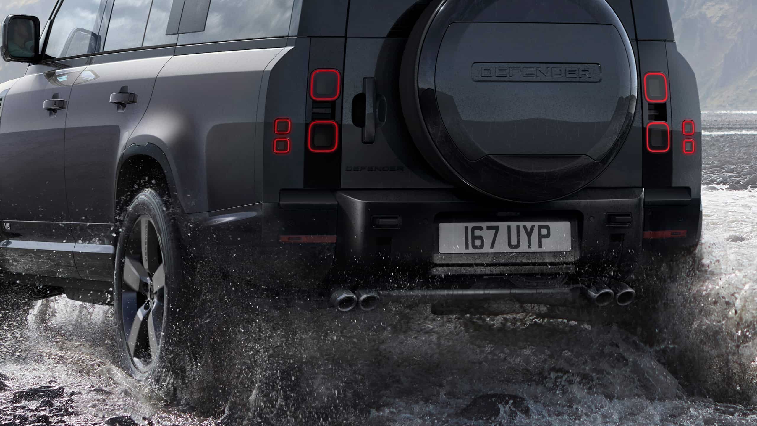 Defender is off roading in the mud of the river