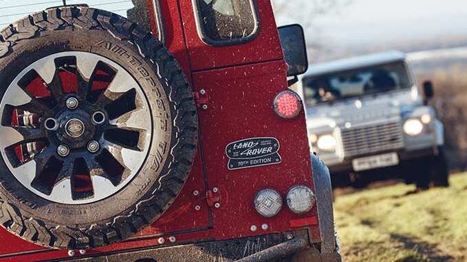 Close up of Land Rover Defender Works V8 70th edition badge and spare wheel